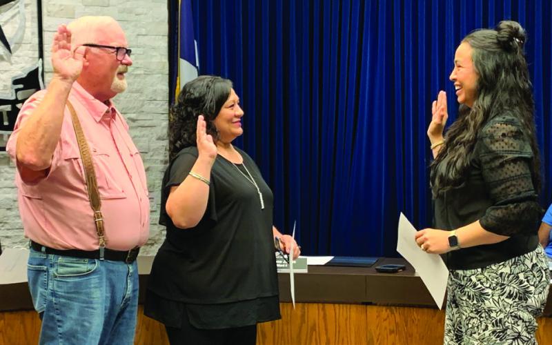 OATH OF OFFICE New city council member Reyes Pequeno (center) and incumbent Mayor Marvin Self take the oath of office under the direction of City Secretary Susan Collazo on Tuesday, May 20, during the regular scheduled meeting. | ANNA GIBSON PHOTO