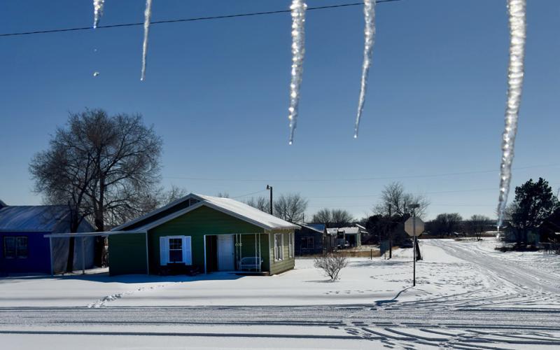 ICICLE SPEARS may have barred the way for exiting many front doors throughout counties below the Caprock until late Monday afternoon, after snow accumulations on sun-heated roofs had thawed somewhat Sunday and refrozen overnight. | TEXAS SPUR PHOTO