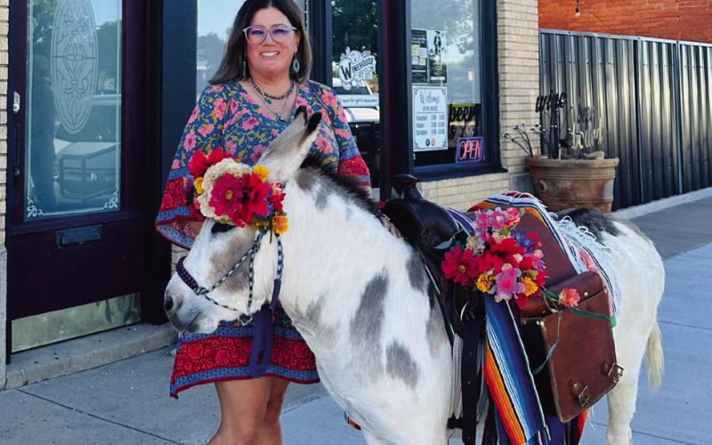 BIRTHDAY DONKEY Whitney Dorsett was surprised with a party for her 40th birthday by her husband and the help of her friends. Together they bought Senior Carrots. Courtney Howard decorated and made the flower crown for the donkey and Lacy Beck brought the donkey to town. Michele Liston was accommodating to allow Senior Carrots into the Winehouse! | COURTNEY HOWARD PHOTO