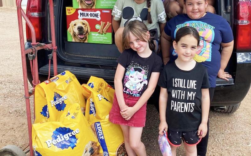 PAWS AND PURPOSE Members of the Post Girl Scouts visited the Post Animal Refuge Center (PARC) on Tuesday, April 14, spending time with shelter dogs and donating food and treats. The group learned about their community while supporting local animal care efforts. | POST DISPATCH