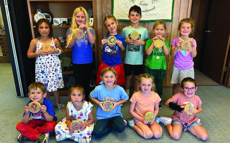 4-H EMBROIDERY Clover Kids and a few third-grade siblings did such a great job learning to embroider, Thursday, September 26. They were taught a simple back stitch with a plastic needle and yarn on burlap. They drew their own picture and picked their colors. Back row: Eva Jo Grizzell, Sara Tadlock, Zoee Ray, Samuel Reiter, Samantah Tadlock, and Kennedy Beck. Front: Raleigh Ray, Eliza Grizzell, Cameryn Clements, Maevery Mason, and Ava Reiter. | XANE REITER PHOTO