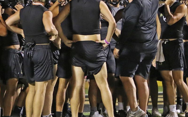 Head Football Coach John Wright addresses the students suited up for the beginning of the 2023 football season. | PHOTO BY ABIGAIL RODRIGUEZ