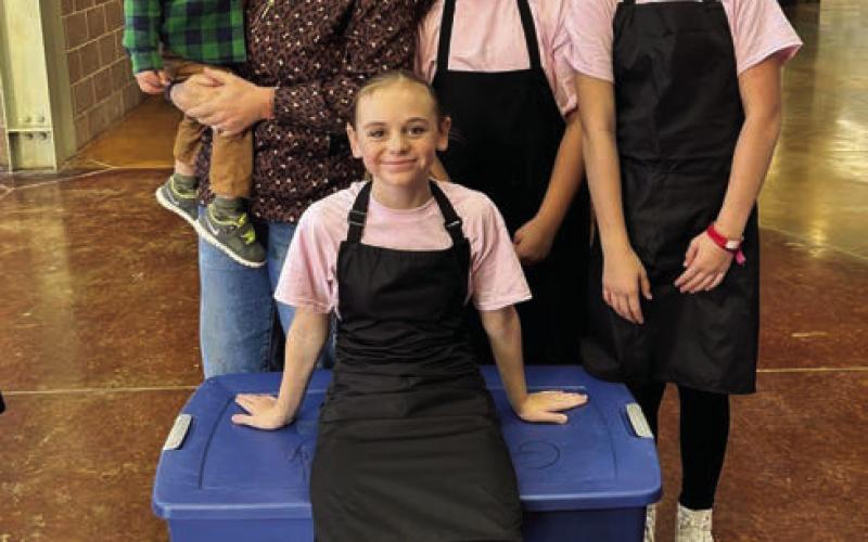 SPICE GIRLS The intermediate culinary artists pose for a picture as they wait in line before their cooking challenge at the Mallet Event Center in Levelland on Tuesday, November 5. The girls named themselves the Spice Girls. Behind them is their coach Hannah Gomez and little Jon Gomez, and the team, Elliot Talerico, Cenci Torres, and Daveigh Gomez. | XANE REITER PHOTO