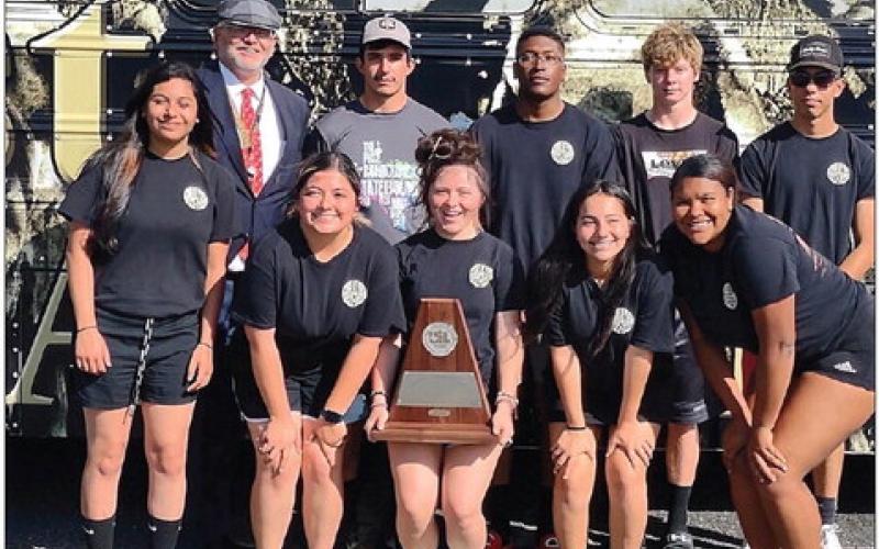 Aaron Rathbun and his seniors display their trophy at regional competition. Courtesy Photo