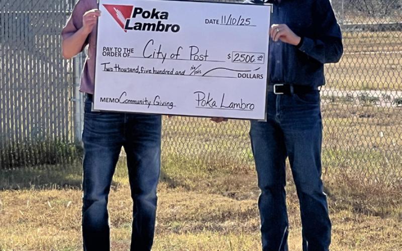 PLAY BALL! Post city manager Rhett Parker (right) recently accepted a donation of $2,500 from Poka Lambro for enhancement of the city’s baseball facilities. | COURTESY PHOTO