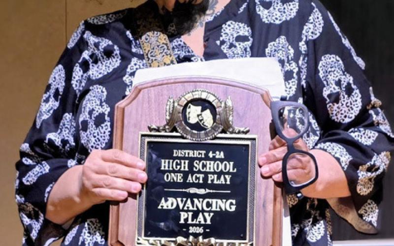 HEADED TO BI- DISTRICT Director Deborah Garoui holds the District 4-2A Advancing Play plaque after Post High School’s championship performance of “Telmah in Death.” | COURTESY PHOTO