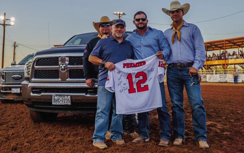 Courtesy Photo Rodney Tidwell received the '12th Man' award from Randon Blacklock, owner of Premier Autos of West Texas. Rodeo board members Wacy Moore and Miles Underwood were present for the award. Rodney is Director/Paramedic at Post-Garza Co EMS.