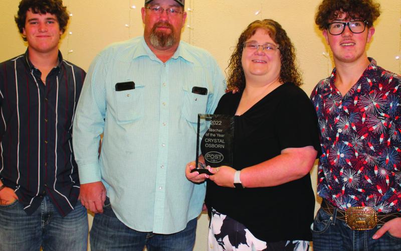2022 Teacher of the Year - Elementary Teacher Crystal Osborn with her family Cooper, Will and Kody.