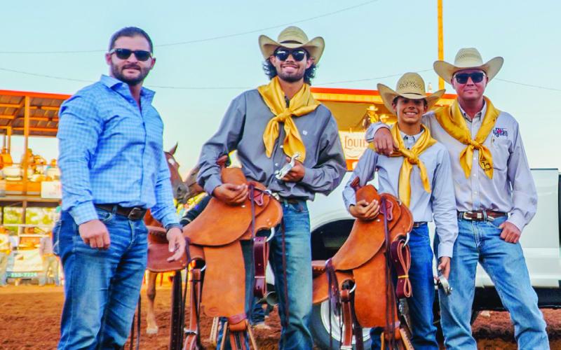 Courtesy Photo Randon Blacklock, Owner of Premier Autos West Texas presents saddles to Dylan Greer and Brazos King. Looking on is Jon Wheeler, President of the Post Stampede Rodeo Board of Directors.