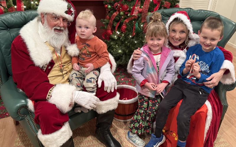 SANTA LISTENS to the Tara and Trent Lawrence family at last week’s Light Up Post evening.