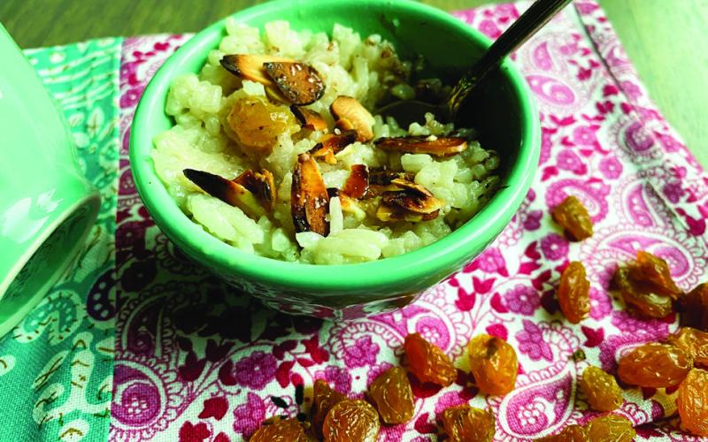 While rice is still hot and in the saucepan, stir in coconut milk, remaining teaspoon of vanilla, and maple syrup. Add the raisins and let cook, stirring occasionally, for 15 minutes. Preheat broiler. Place almonds onto a small baking pan. Sprinkle evenly with sugar. Place under the broiler for 2 to 3 minutes to toast until golden brown, (watch closely to avoid burning). Divide pudding into dishes to serve, and top with a portion of brûléed almonds. Makes 3 to 4 servings. Photo by Angeline LaRue
