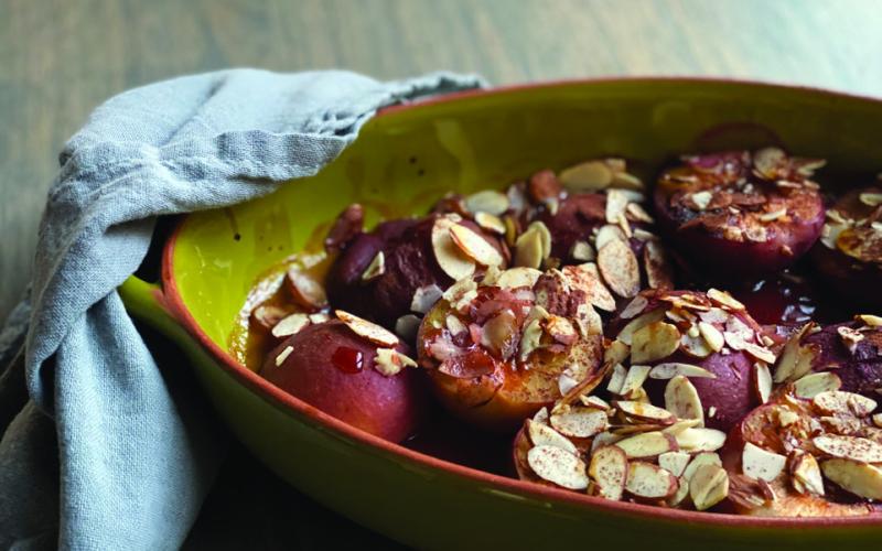 SWEET AND DELICIOUS Roasted plums with almonds make for a delightful and simple dessert or snack. This dish can be enjoyed warm, perhaps with a dollop of mascarpone or yogurt for a creamy contrast. | ANGELINA LARUE PHOTO