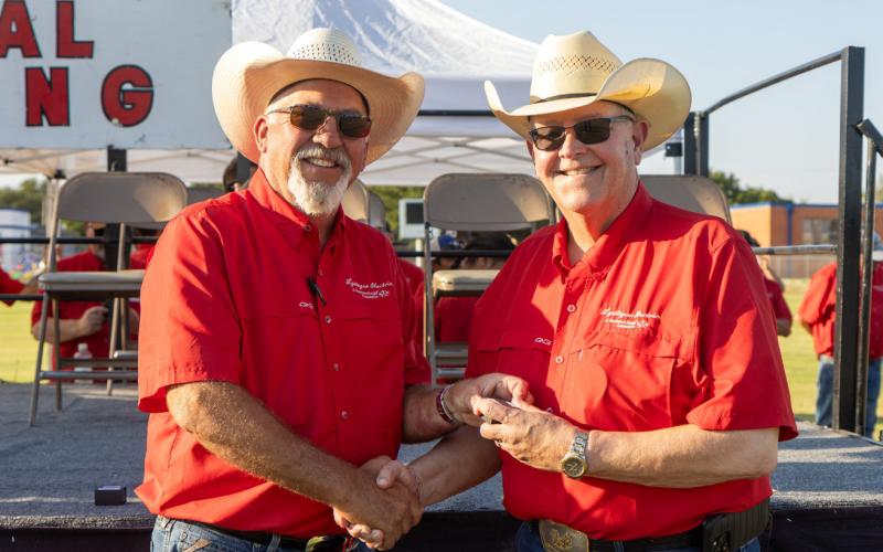 TIME TO RETIRE AND RAISE COWS Greg Henley (right) will retire as CEO of Lyntegar Electric Cooperative this month after a 40-year career with the cooperative. Board president Ben Franklin presented a token of appreciation from the organization. | COURTESY PHOTO