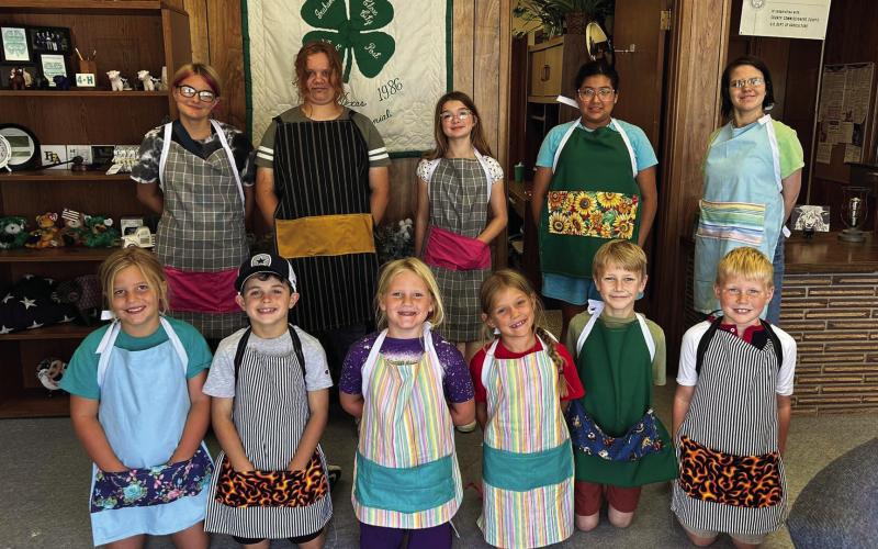 SEWING CLASS 4-H students met at the Garza County Extension Office for a sewing class last Wednesday, each creating their own apron. In the back row, Trinity Arocha, Brooklyn Hyndman, Amelia Miller, Aalayah Guerrero, and Sarah Palmer. In the front, Morgan Tadlock, Samuel Reiter, Sara Tadlock, Zoee Ray, Samuel Gibson, and Connor Griffin. | XANE REITER PHOTO