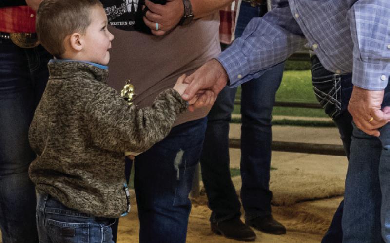 Garza County Judge Lee Norman presents Grady Dorsett with a trophy for his hard work and performance during the 2023 GCJLA show held Jan. 14 at the Syd Conner Show Barn. Each participant in the Pee Wee divisions received a trophy. Photo by Ron Francis