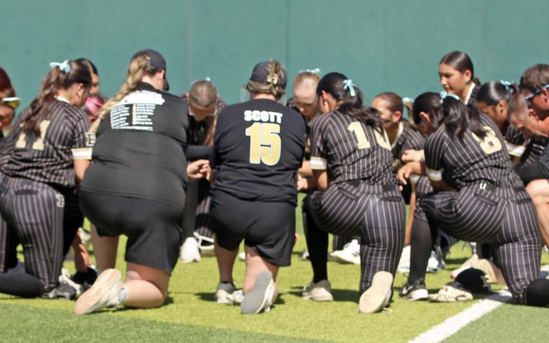 LADY LOPES Members of the Post High School Lady Lopes softball team gathered for a pregame prayer before their bi-district playoff game April 24 at Lubbock Christian University. | COURTESY PHOTO