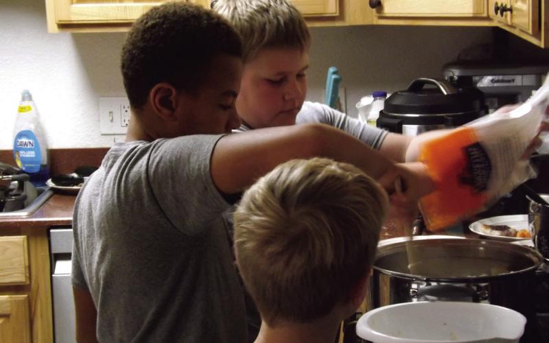 BOYS COOKING Monday, October 15, the 4-H junior food challenge team members, EJ, Philemon, and Samuel raced the clock while preparing a hearty meal. | PAUL GIBSON PHOTO