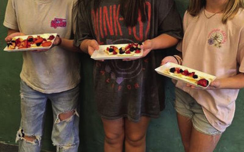 GIRLS COOKING Monday, October 15, the 4-H intermediate food challenge team members Daveigh, Elliot, and Cenci made fruit pizza crackers. They are working hard to prepare for the competition in November. | XANE REITER PHOTO