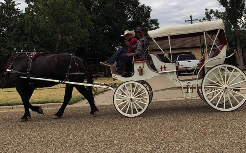 RIDE THROUGH You never know what you'll see on Main Street. Cody Marshall and Reece Belongia took a trip through town on July 20 in the Cross H carriage. | ANNA GIBSON