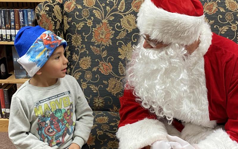 SANTA VISITS THE LIBRARY Post Public Library hosted“Cookies and Stories with Santa”last week. Children lined up to talk to the ole guy just one more time. Sharing secrets and wishes is Kyler Guerra. | PHOTO PROVIDED