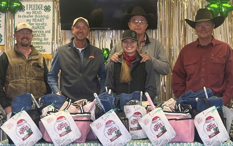 GIVING BACKTOTHE COMMUNITY 4-H partnered with the Post Stampede Rodeo Board to deliver gift baskets to t 15 individuals from the nursing home who do not have families. Rodeo board members Zane Marts, Shawn Pennell, Paul Peterson and Jon Wheeler, along with 4-H member Sylee Peterson deliver gift baskets to each of the individuals just in time the Christmas holiday. | DANYA PETERSON PHOTO
