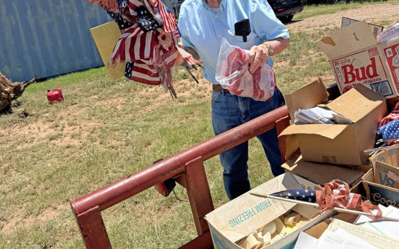 UNFLAGGING RESPECT Post VFW member Tim Lawrence helps with proper disposal of American flags brought to the organization throughout the year by schools, pos offices, government institutions, and other organizations and individuals. | LACEY REITER | POST DISPATCH