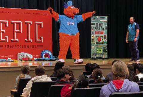 EPIC MINISTRIES Daniel Monplaisir introduces Kazoo the mascot of EPIC Ministries to Post ISD elementary school students, Wednesday, November 20. Monplaisir teaches valuable lessons through metaphors. | ANNA GIBSON PHOTO