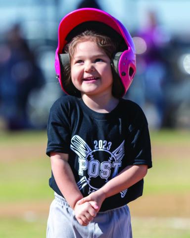 Unidentified little girl shows her excitement as she gets up to bat for the first time. A uniform, pink helmet and bat – could this day get any better? Ron Francis Photo