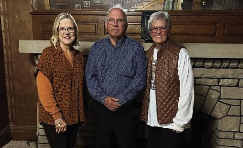 Standing in front of the fireplace at the C.W. Post on Main Street are Amity President Marsha Norman, Curtis Hudman, and Vice President Nancy Thuett. PHOTO PROVIDED