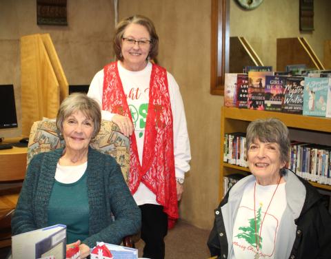 OPEN HOUSE Post Public Library hosted a Christmas Open House last Thurs. Dec. 14. Librarian Pam Humble served hot cider and cookies to avid readers Beth Cook and Carolyn Black. The library will be closed today through Dec. 26. Pam reminds everyone to come in next week, Dec. 27 through Dec. 29 and check out the new books selections. | JULIA CHILDS PHOTO