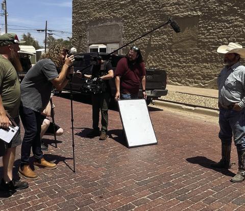 FILM CREW - Calina Mishay, mural artist, and her film crew were in the Post last week to capture scenes around town and interview people for her new TV series called Cal’s Hometown Revival. Jeff Williams is shown talking about the mural painted downtown and the significance the mural paintings have had on Post. Cal’s Hometown Revival will air on Destination America by Discovery starting October 1. More information as the date gets closer. | STAFF PHOTO