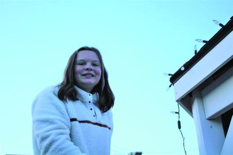 Adyson Parker a sixth grader at Post Middle School volunteered to hang lights at the park. Staff Photo