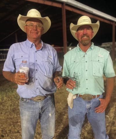 STEER STOPPING Paul Peterson presents Justin Johnson with bridal bits after winning the Steer Stopping. | COURTESY PHOTO