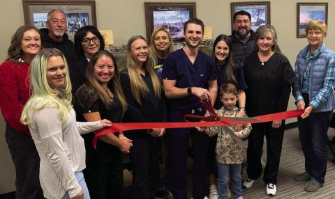 POST EYECARE Tuesday, November 19, Dr. Garrett Wentz cut the ribbon to the newly opened Post Eyecare located at the Garza County Healthcare District. In support are Traci Jarrett, Jacey Cathey, Randy Conner, Christina Jones, Dr. Xochitl Anderson, Brandy Fannon, Janie Suber, Dr. Garrett Wentz with his wife Kara and son Graham, Chita Hattaway, Jamie Hernandez, and JoAnn Travis. | ANNA GIBSON PHOTO
