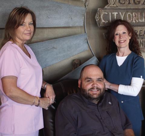 NEW BUSINESS Brant Guthrie, Pharmacist and Owner, sits long enough for a photo with his staff, Regena Isbell and Debbie Owen, prior to openingThe Pharmhouse Drugs and Gifts on Monday. The Grand Opening is planned for Friday, April 19. A ribbon cutting will take place at 10 a.m. | JULIA CHILDS PHOTO