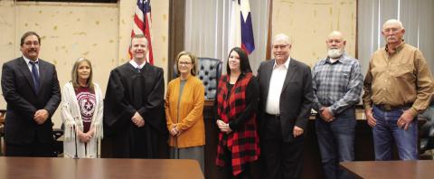 District Judge Reed Filley held swearing-in ceremonies for Garza County’s newly elected officials on Sunday afternoon, Jan. 1. Standing left to right are Giles Dalby, Jr., Terri Laurence, Filley, LuAnne Terry, Angela Massey, Lee Norman, Gordon Terry, and Kim Wilks. Photo by Julia Childs