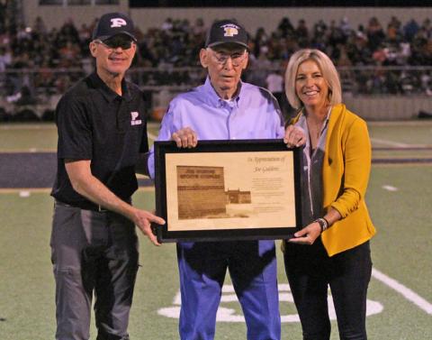 HONORARY TITLE Joe Giddens (center) was honored by Post ISD during the homecoming game, Sept. 19. After 28 years of serving the Post school district, the board of trustees voted in February 2025 to name the field house the Joe Giddens Sports Complex. | RYLAN MORRIS PHOTO