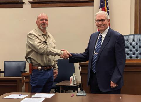 OATH OF OFFICE Newly elected Sheriff Michael Isbell shakes the hand of Garza County Judge Lee Norman after taking the Oath of Office a minute after midnight on Jan. 1, 2025. | ANNA GIBSON PHOTO