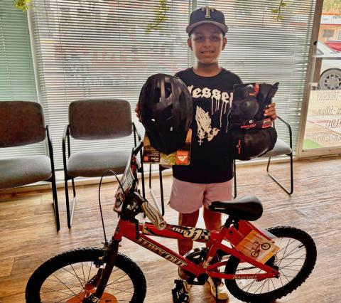 PARADE PRIZE Jonah Hernandez received his new bicycle after being selected as the winner of the boys’ drawing sponsored by Post Community Recovery Center during the Fourth of July Bicycle Parade. | COURTESY PHOTO