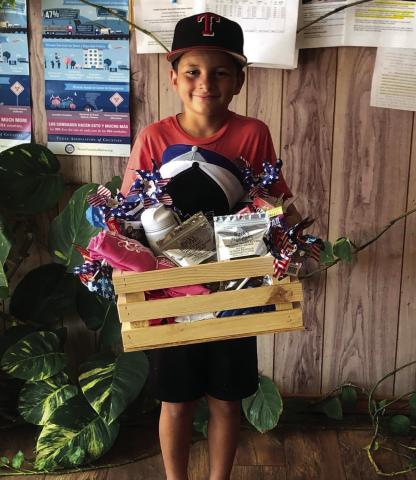 IMPRESSIVE DISPLAY Legend Odom is presented with a gift basket for receiving the Best Entry award from July 4 parades’overall float. | DAWN GRAVES PHOTO