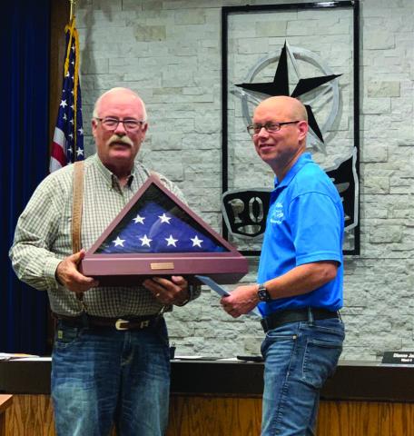 COUNCILMAN RECOGNIZED, Mayor Marvin Self is shown giving a flag that has flown over Post to Councilman Jeff Hood, in recognition by the city after serving five years which started as an appointed position in 2019. | ANNA GIBSON PHOTO