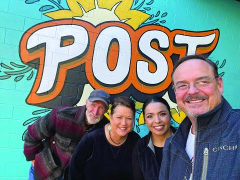 COMMUNITY CENTER City Manager J. Rhett Parker is with Asst. City Secretary Susan Collazo, City Secretary Meg Nelson and City Animal Control and Code Enforcement Officer Eddie Pitts pose in front of the new mural at the Post Community Center. The mural is located in the courtyard at the east entrance of the building and was painted by Street Artist Calina Mishay Johnson. | PHOTO PROVIDED