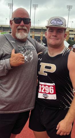 SILVER SHOT Coach John Wright (left) and Post senior Mason Wright celebrated his second-place finish in the shot put May 2, in his third trip to the State meet of his high school career. | RUSS MORRIS