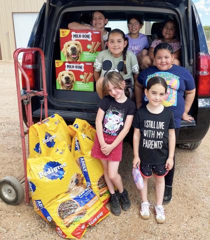 PAWS AND PURPOSE Members of the Post Girl Scouts visited the Post Animal Refuge Center (PARC) on Tuesday, April 14, spending time with shelter dogs and donating food and treats. The group learned about their community while supporting local animal care efforts. | POST DISPATCH