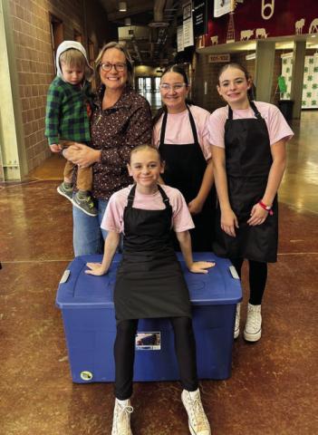 SPICE GIRLS The intermediate culinary artists pose for a picture as they wait in line before their cooking challenge at the Mallet Event Center in Levelland on Tuesday, November 5. The girls named themselves the Spice Girls. Behind them is their coach Hannah Gomez and little Jon Gomez, and the team, Elliot Talerico, Cenci Torres, and Daveigh Gomez. | XANE REITER PHOTO