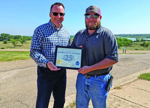 QUARTER CENTURY The White River Reservoir Water Treatment Plant was recognized last week with a 25 Year Honored Institution award. Staff member Brice Bownds (right), the plant’s current observer, accepted the award from Lubbock Weather Forecast Office meteorologist in charge (MIC) Justin Weaver (left). | COURTESY PHOTO