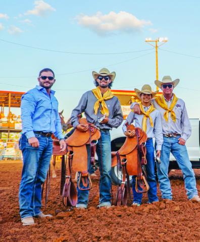 Courtesy Photo Randon Blacklock, Owner of Premier Autos West Texas presents saddles to Dylan Greer and Brazos King. Looking on is Jon Wheeler, President of the Post Stampede Rodeo Board of Directors.