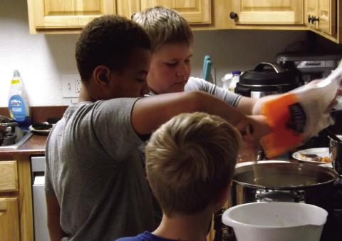 BOYS COOKING Monday, October 15, the 4-H junior food challenge team members, EJ, Philemon, and Samuel raced the clock while preparing a hearty meal. | PAUL GIBSON PHOTO