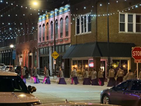 SURREAL SCENE in predawn downtown Springfield, Missouri, April 30 is really nothing more than the Southwest Missouri State flag corps proceeding to their lineup point for the filming of an NBC-TV“Today Show Third Hour Live”segment on the birthplace of Route 66.