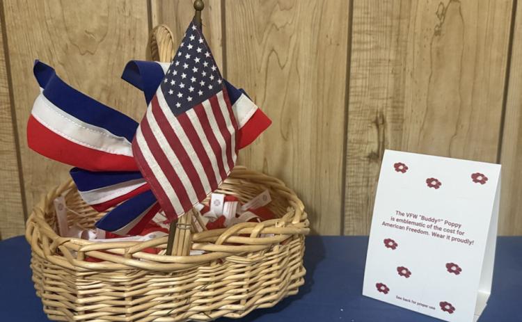 A bright red Buddy Poppy, the official memorial flower of the Veterans of Foreign Wars since 1922, is a symbol of honoring fallen service members and supporting living veterans. | COURTESY IMAGE